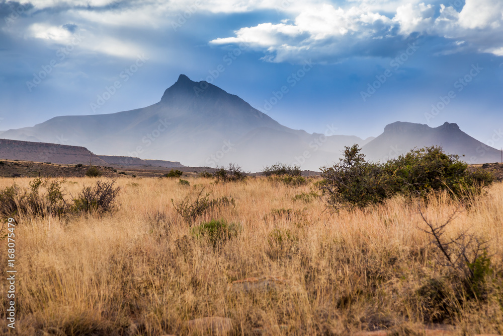 Rain falling in the Karoo on a usually dry and rugged terrain.