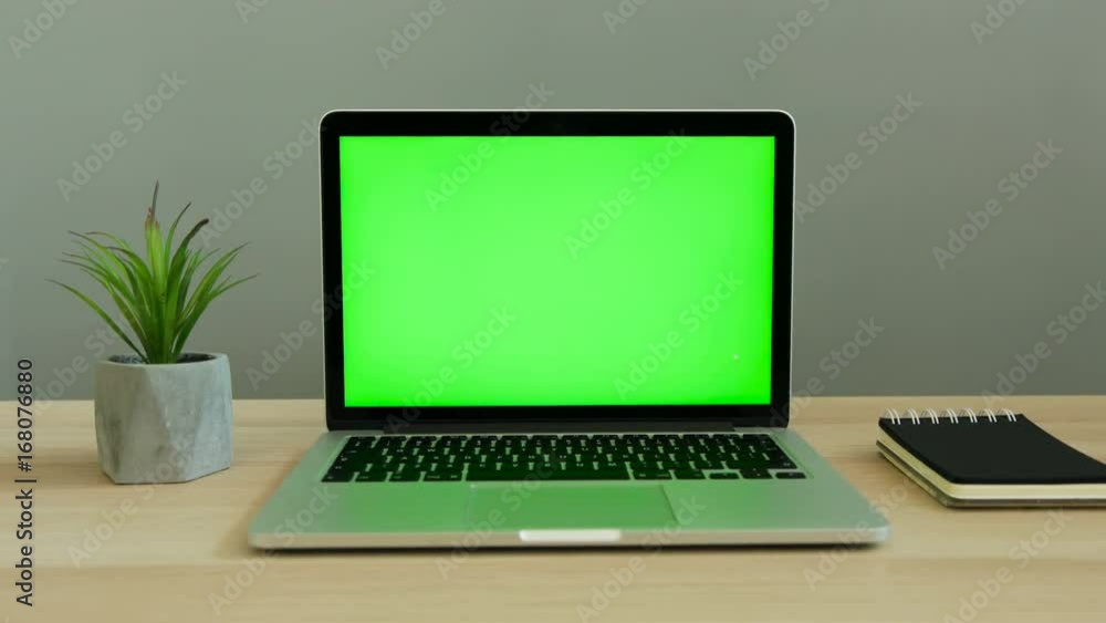 Close up shot of laptop with green screen on the table. Chroma key. Close up shot of laptop with green screen on the table. Chroma key.