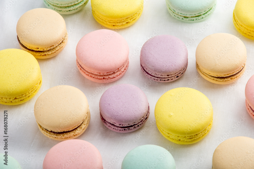 Fototapeta premium Colorful macarons on a white background. French dessert