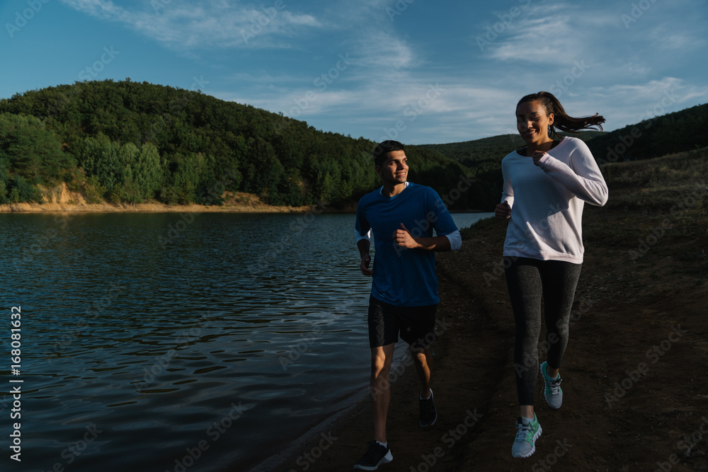Fototapeta premium Young happy couple training to be fit together