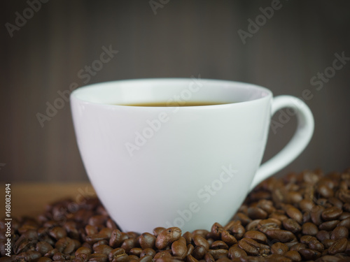 Coffee Cup Placed in groups of coffee beans.