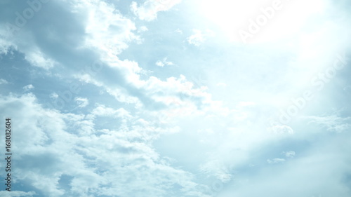 Soft light blue sky with white cloud for background.