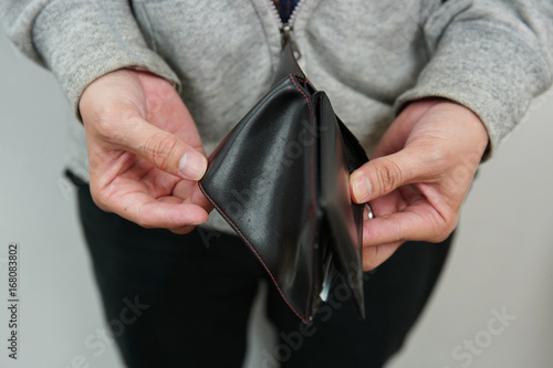 a man holding empty wallet