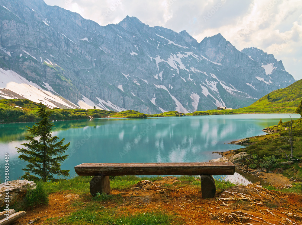 Wooden bench near mountain lake in the Swiss. Wooden bench near mountain lake in the Swiss.