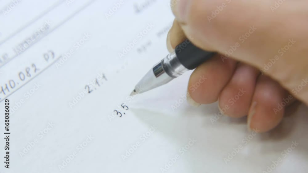 Macro Woman Writes Data with Black Pen on Sheet in Study Macro Woman Writes Data with Black Pen on Sheet in Study