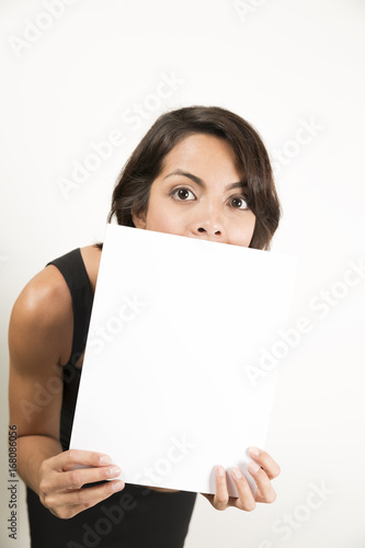 Beautiful young woman holding a blank sheet of paper