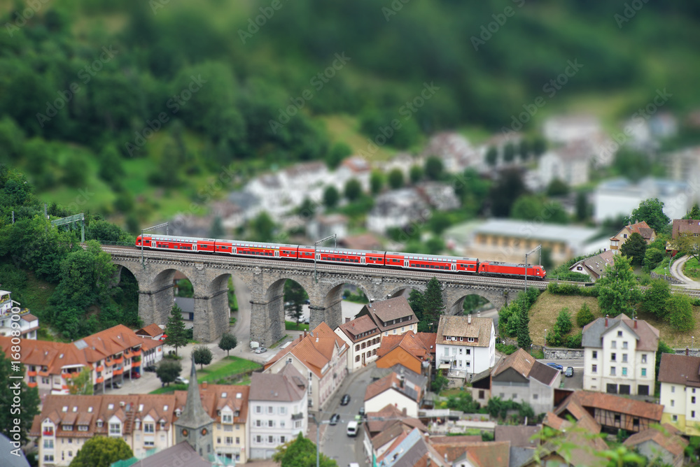 Train crossing old viaduct in Black Forest / Schwarzwald (pseudo miniature view)