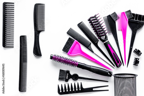 Combs and hairdresser tools in beauty salon on white background top view