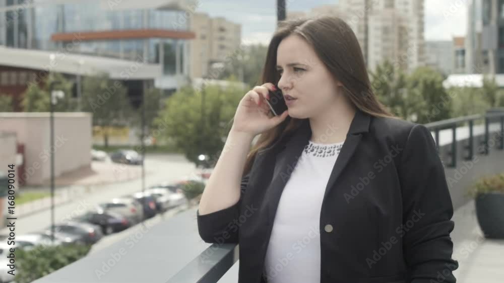 Businesswoman talking phone at handrail Businesswoman talking phone at handrail