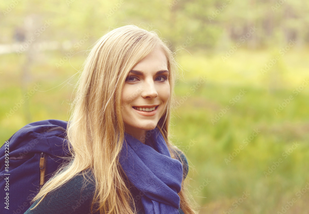 Close-up portrait of a happy, beautiful blond girl walking in forest and swamps. Camp, tourism, hiking concept. Close-up portrait of a happy, beautiful blond girl walking in forest and swamps. Camp, tourism, hiking concept.
