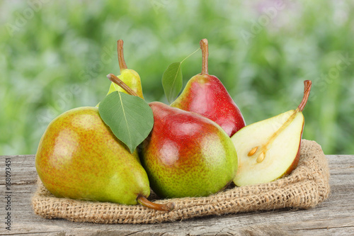 pear with leaf on old wooden table with garden background