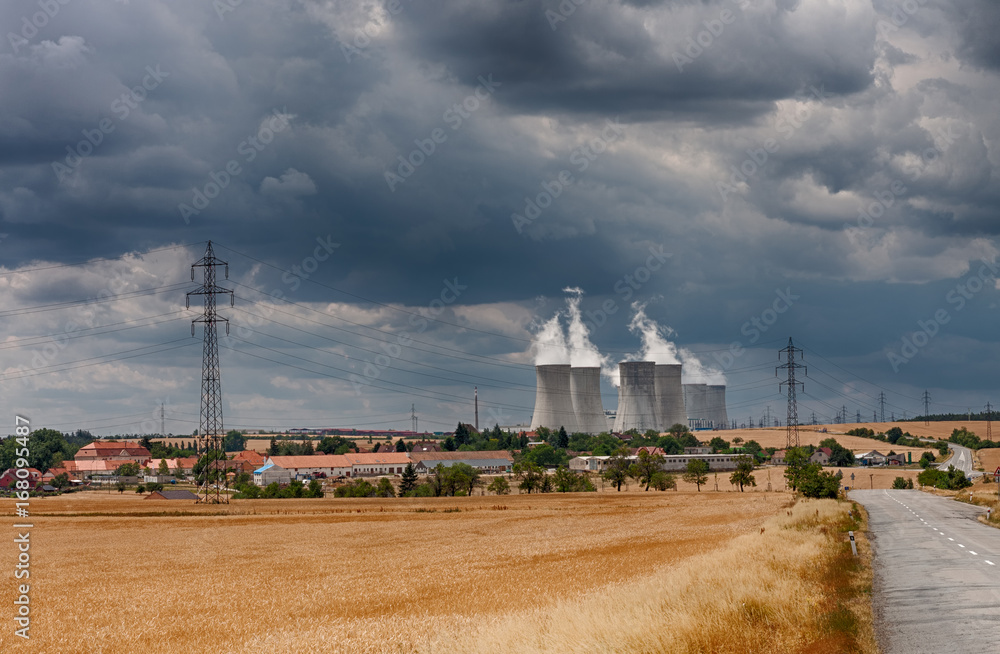 Aerial view of nuclear power station with cooling towers against cloudy sky Aerial view of nuclear power station with cooling towers against cloudy sky