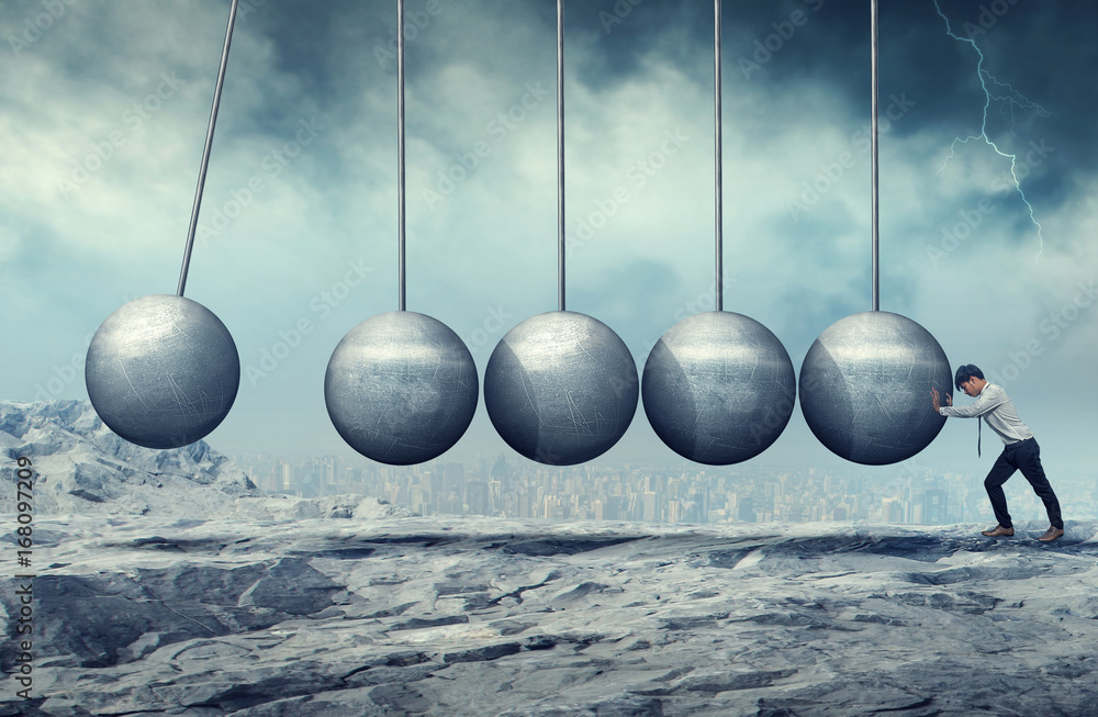 A businessman pushing at a hanging unmoving wrecking ball. Heavy burden. Business heavy tasks and problems concept. A businessman pushing at a hanging unmoving wrecking ball. Heavy burden. Business heavy tasks and problems concept.