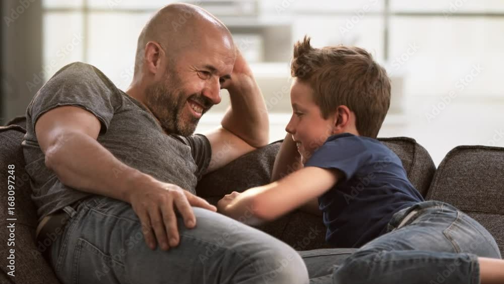 Father and son talking on the couch Father and son talking on the couch