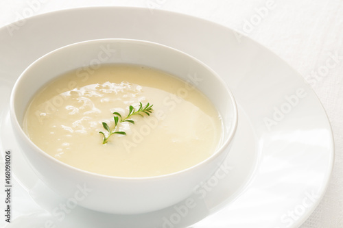 chicken soup with lemon, egg, and rice decorated with thyme