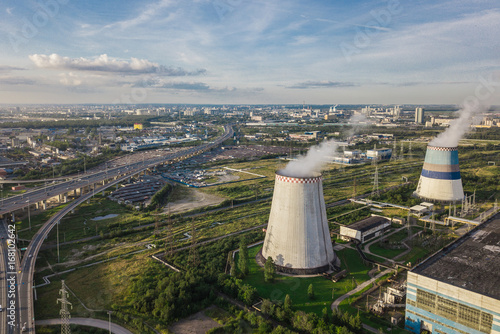 Aerial view of power station on background of cityscape