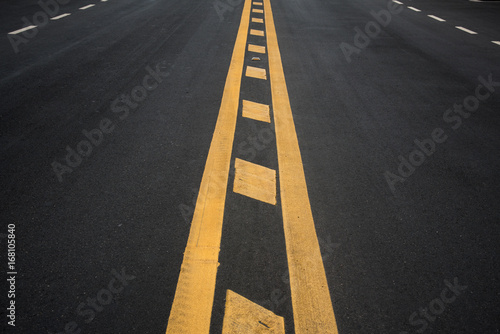 Yellow stripes on asphalt road