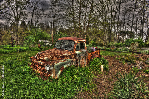 Old rusted car in yard