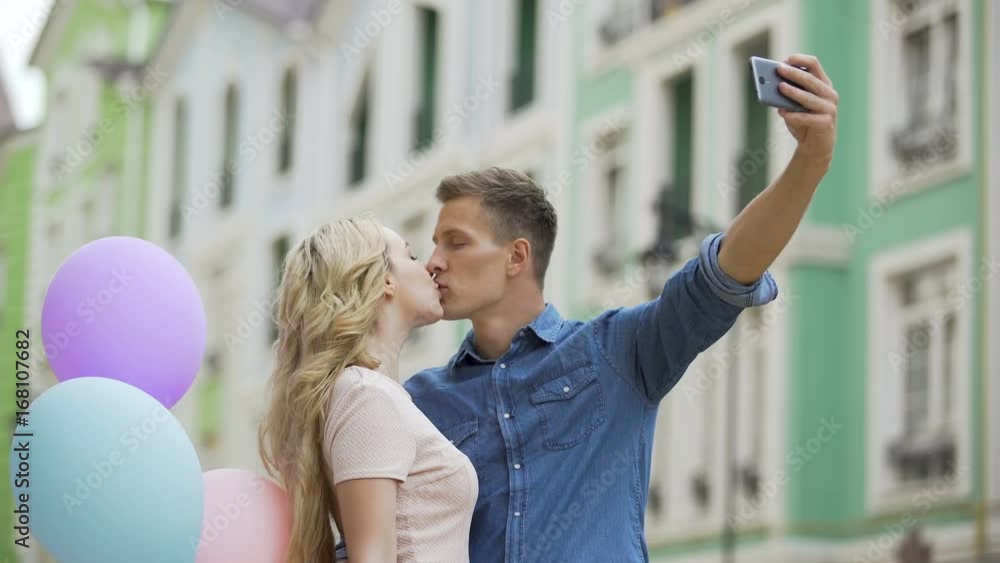 Girlfriend and boyfriend kissing in street and taking selfie, romantic photos Girlfriend and boyfriend kissing in street and taking selfie, romantic photos