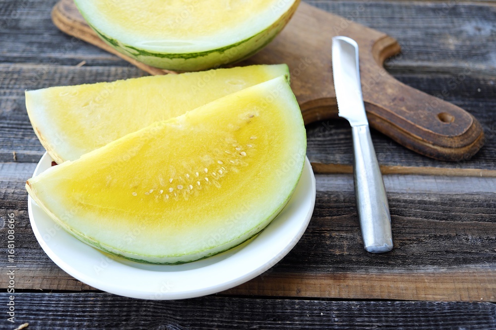 Fresh yellow watermelon on the plate view Fresh yellow watermelon on the plate view