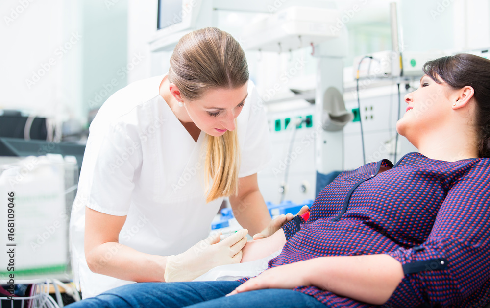 Nurse applying access for blood drawing and shots at upper arm of patient Nurse applying access for blood drawing and shots at upper arm of patient
