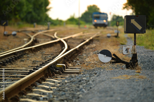 train with train tracks and switch in the evening light
