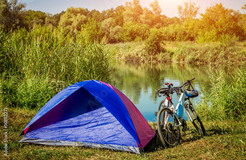 Tent and a couple of bikes in front of the lake