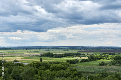 View from the hill to the green valley in cloudy weather. Russia