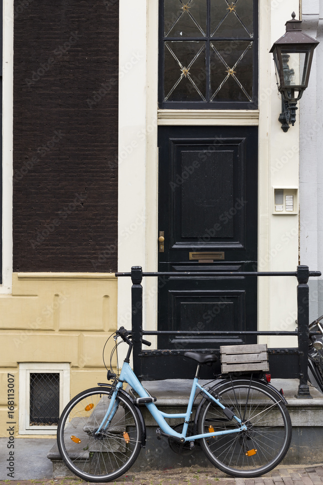 Typical Amsterdam's facade with bicycle in front of it, Netherlands