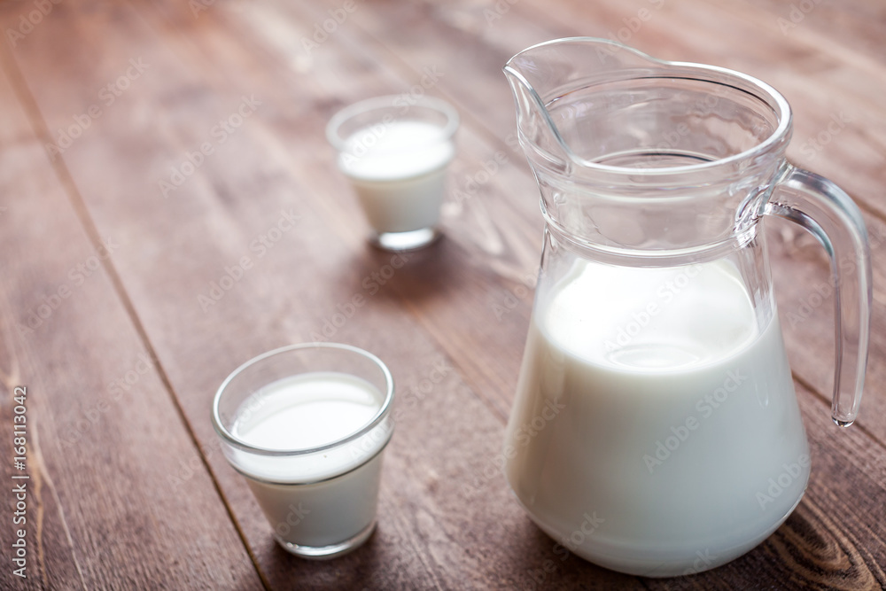 milk and glasses of milk on a wooden rustic table. milk and glasses of milk on a wooden rustic table.