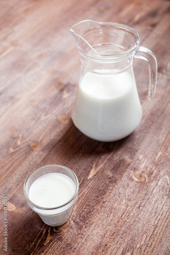 milk and glasses of milk on a wooden rustic table. milk and glasses of milk on a wooden rustic table.