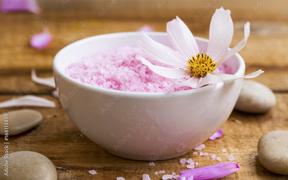 Spa bath salt bowl with flower.Pink bath salt wellness composition Spa bath salt bowl with flower.Pink bath salt wellness composition