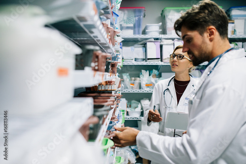Pharmacists checking inventory at hospital pharmacy photo