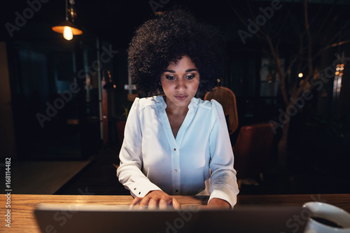 Photography Businesswoman working late on laptop in office