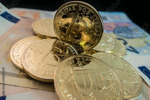 coins of bitcoin on dollar notes