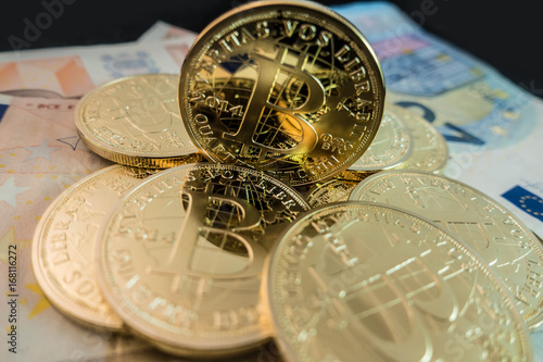 coins of bitcoin on dollar notes