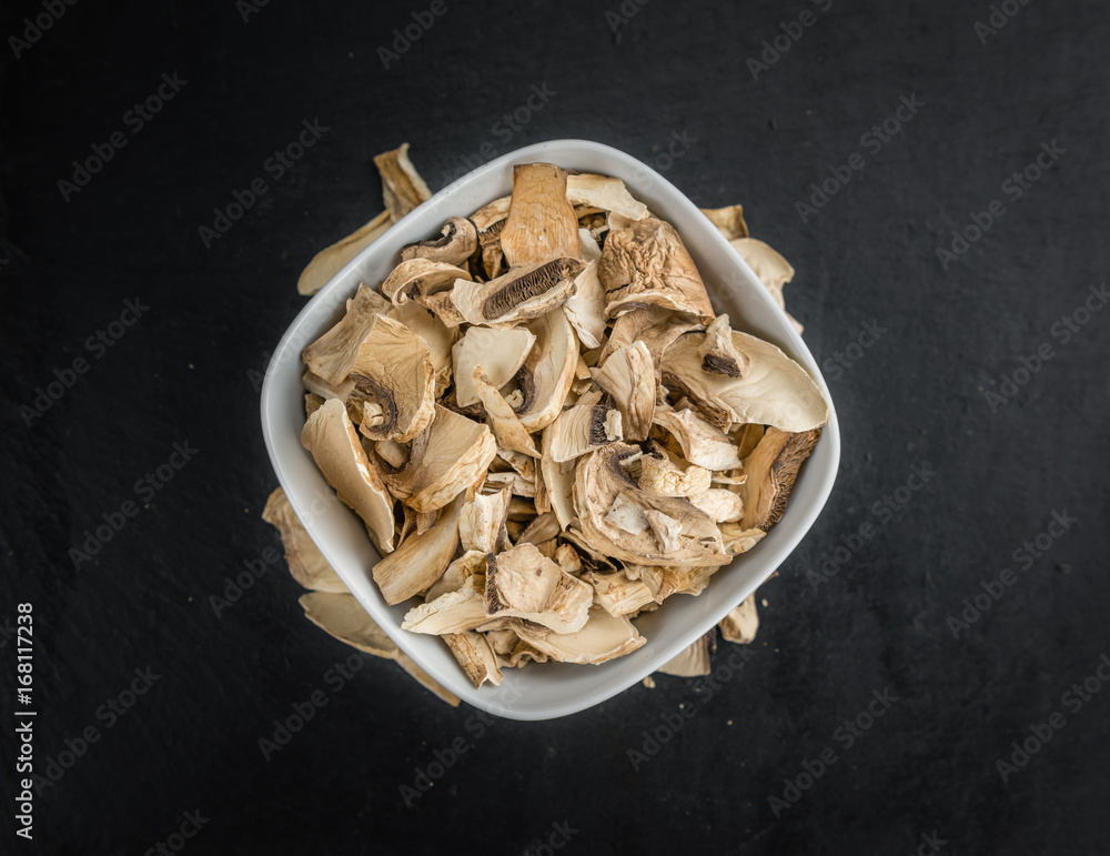 Dried white Mushrooms on a slate slab, selective focus Dried white Mushrooms on a slate slab, selective focus