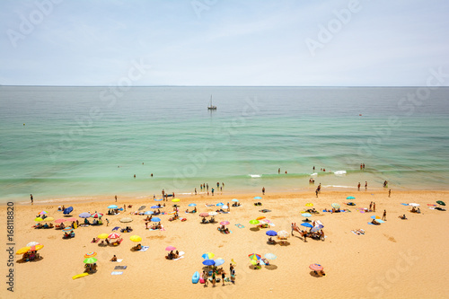 View from the cliffs to busy beach Praia do Porto de Mos near Ponta da Piedade, Lagos Algarve Portugal © ah_fotobox