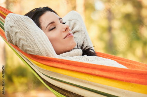 Woman Relaxing on a hammock. Warm autumn