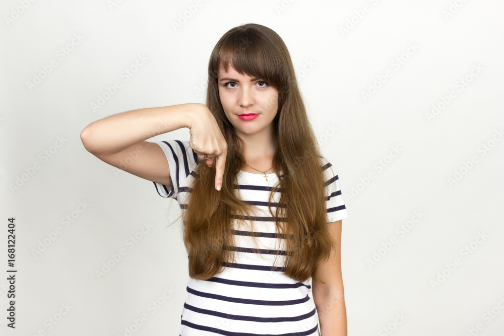 Smiling beautiful teen girl pointing fingers down Smiling beautiful teen girl pointing fingers down