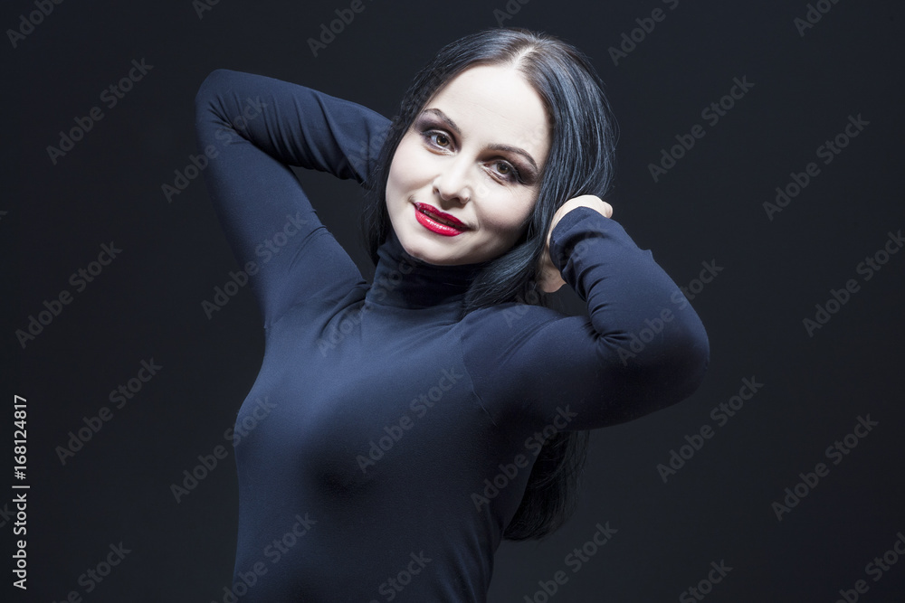 Fototapeta premium Portrait of Beautiful Relaxed Caucasian Mature Brunette. Posing in Black Body suit Against Black.