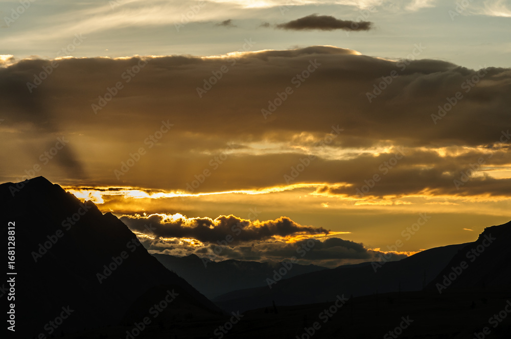 Scenic sunset and sunrise in mountainous region of Altai