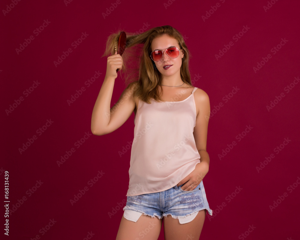 Young cute girl with comb, studio Young cute girl with comb, studio