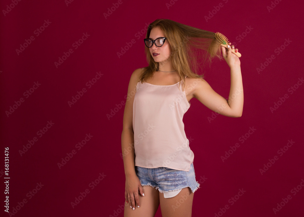 Young cute girl with comb, studio Young cute girl with comb, studio