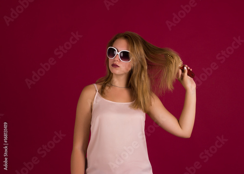 Young cute girl with comb, studio 