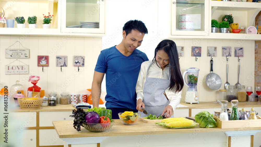 Young Asian wife is preparing clean food for husband