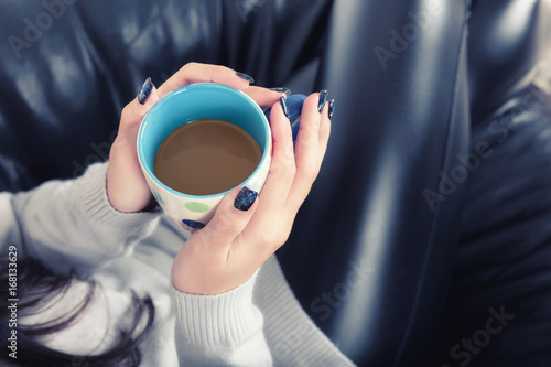 Beautiful young girl with cup of coffee portrait on winter season.