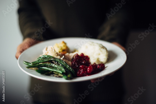 Women holding plate of thanksgiving dinner photo