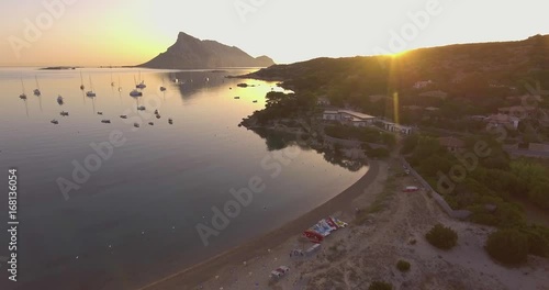 Aerial, beautiful empty beach in a bay in Sardinia island on sunrise
