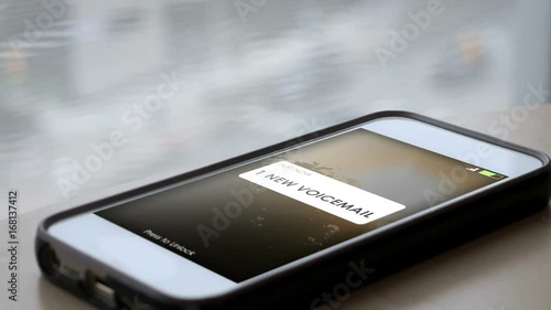 A smartphone with a 1 new voicemail message appearing on screen